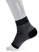 Black and gray sock worn by a person on a white background