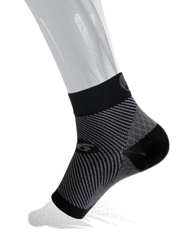 Black and gray sock worn by a person on a white background