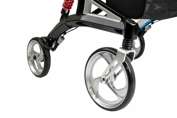 Close-up of the silver tri-spoke wheels and red suspension springs on a Hero Medical Outdoor Lite Walker