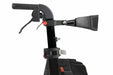 Close-up of the height-adjustable handle and brake system of a Hero Medical Outdoor Lite Walker featuring an ergonomic grip, a red adjustment knob, and a padded backrest attachment