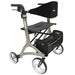 Metallic gray Rolio Plus four-wheel walker with a black mesh seat, backrest strap, and a front storage bag.