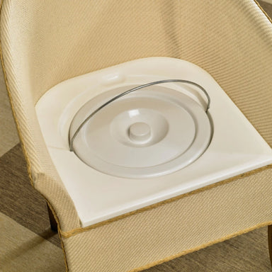 Close-up of wicker commode chair with bucket and lid